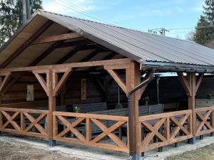 a large wooden pavilion with a metal roof at Jedlinka in Palota