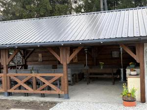 a large wooden pavilion with a table and benches at Jedlinka in Palota