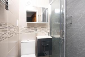 a bathroom with a toilet and a sink and a shower at Tŷ Gwyn Bach, Conwy in Conwy +46 photos