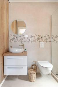 a bathroom with a sink and a toilet and a mirror at Sea View House with Jacuzzi - Casa Bianca Brač in Selca +20 photos