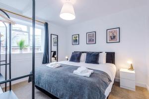 a bedroom with a bed with towels on it at 15A Well Street in Ruthin