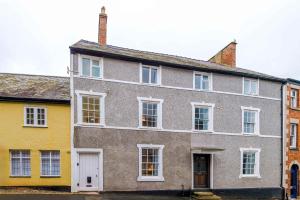 an old house with yellow and gray at 15A Well Street in Ruthin
