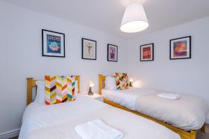 two beds in a room with white walls at 15A Well Street in Ruthin +28 photos