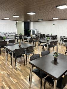 a large room with tables and chairs in it at Mega Palace Hotel in Morrinhos
