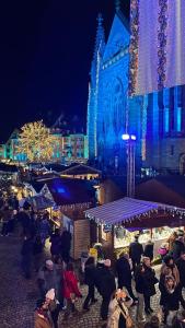 a group of people walking around a christmas market at night at Cocoon Spa in Issenheim