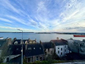 a view of a body of water with houses and a boat at 2 Bed Apartment with Harbour Views Apt 2 in Cobh