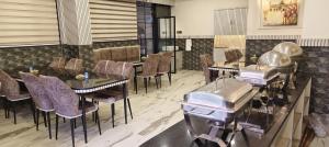 a restaurant with tables and chairs in a room at D. K. INTERNATIONAL HOTEL PVT. LTD in Calcutta Bara Bazar