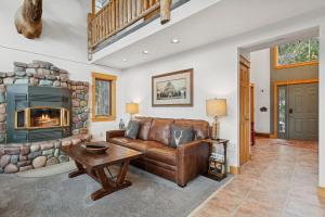a living room with a couch and a fireplace at Elk Run in Whitefish +42 photos
