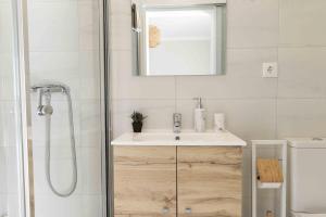 a bathroom with a sink and a shower at Olive House in Fátima