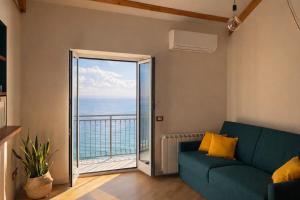 a living room with a couch and a view of the ocean at Marilú vista mare con giardino in Genoa