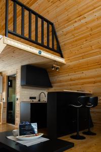 a kitchen with a wooden ceiling with a staircase at Lumina Cottage in Gudauri