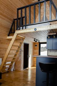 a wooden cabin with a staircase in a room at Lumina Cottage in Gudauri +6 photos