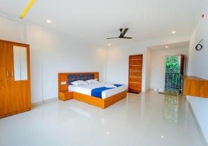 a bedroom with a bed and a ceiling fan at Vythiri Palace Wayanad Pool Resort - Mist Climate & India's First Apple Infinity Pool in Vythiri