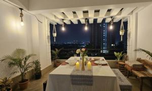a table in a room with a view of the city at Vythiri Palace Wayanad Pool Resort - Mist Climate & India's First Apple Infinity Pool in Vythiri +49 photos