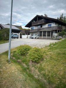 a house with cars parked in front of it at Semesterparadis in Strömstad