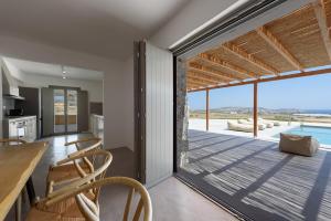 a kitchen and dining room with a view of the ocean at Aegean Gem Villa in Mármara
