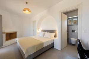 a white bedroom with a bed and a bathroom at Aegean Gem Villa in Mármara +41 photos