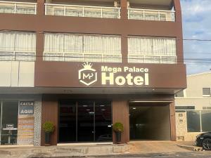 a large hotel with a mage palace hotel sign on it at Mega Palace Hotel in Morrinhos
