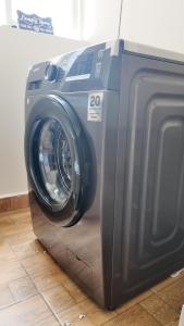 a washing machine is sitting on the floor at Modern 3BR Apt with Pool within UN-Approved Zone, Kiambu Rd in Nairobi