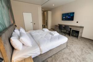 a bedroom with a large bed and a fireplace at Hotel Oasis in Vinnytsya