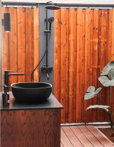 a bathroom with a black sink on a counter at OBOĒ Gardenstē in Pereybere +65 photos