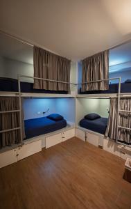 two bunk beds in a room with wood floors at Dreamer Beach Club in San Andrés +46 photos