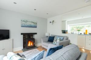a living room with two couches and a fireplace at Tŷ Gwyn Bach, Conwy in Conwy