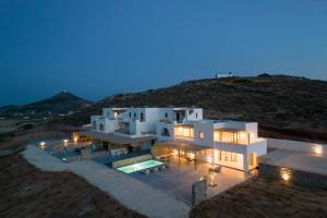 a large white house at night with a mountain at Aegean Gem Villa in Mármara