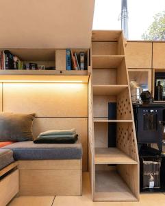 a small bedroom with a bunk bed and shelves at La Tiny De Fy in Aywaille