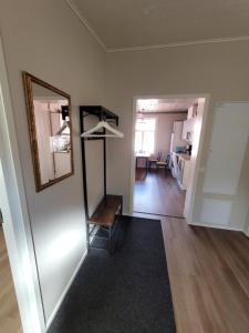 a living room with a mirror and a table in a room at Majoitus Merihelmi in Kristinestad