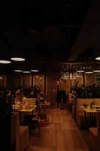 a restaurant with tables and chairs and lights at Hotel Oasis in Vinnytsya
