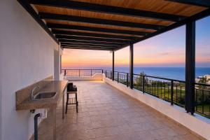 a balcony with a view of the ocean at Livia - Vikles Villas in Pomos