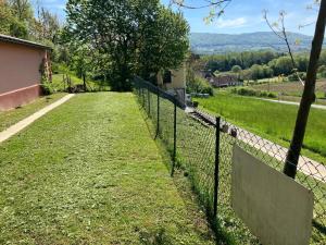 a fence in front of a field of grass at Ferienhaus Krenn in Bad Gleichenberg