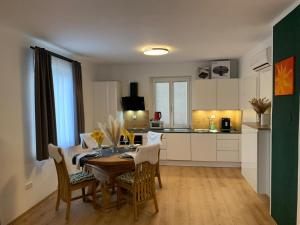 a kitchen and dining room with a table and chairs at Ferienhaus Krenn in Bad Gleichenberg