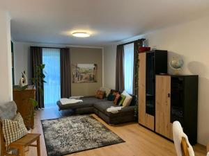 a living room with a couch and a chair at Ferienhaus Krenn in Bad Gleichenberg