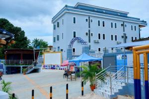 a large white building with a roller coaster at Bluespring luxury hotel in Elu