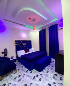 a bedroom with a blue bed and blue curtains at Bluespring luxury hotel in Elu