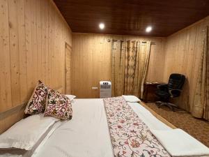a bedroom with a bed and a desk and a chair at Favela Headrooms in Srinagar +21 photos