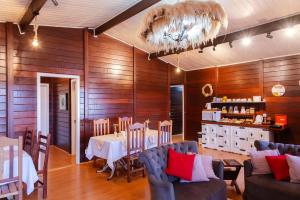 a dining room with wood paneling and a table and chairs at Pousada do Vento in Campos do Jordão