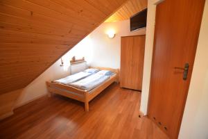 a small bedroom with a bed in a attic at Pokoje Gościnne Brynkus in Białka Tatrzańska