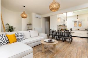 a living room with a white couch and a table at Sarris Village Luxury 2 in Sarakíniko