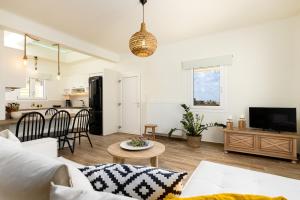 a living room with a couch and a table at Sarris Village Luxury 2 in Sarakíniko