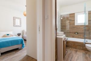 a bathroom with a bed and a tub and a sink at Sarris Village Luxury 2 in Sarakíniko +25 photos