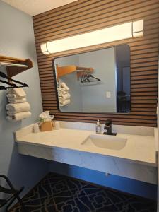 a bathroom with a sink and a large mirror at Sumner Motor Inn in Sumner +30 photos