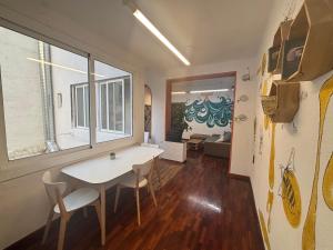 a dining room with a table and chairs in a room at Tarragona Hostel in Tarragona