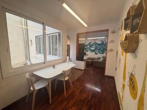 a room with a table and chairs and a window at Tarragona Hostel in Tarragona