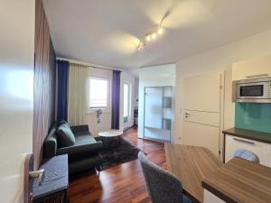 a living room with a couch and a table at Ferienwohnung Traismauer TOP 2 in Wagram an der Traisen