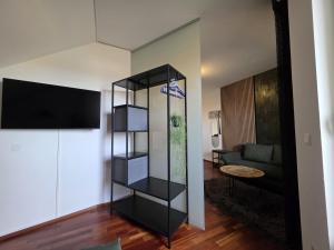a living room with a black book shelf at Ferienwohnung Traismauer TOP 2 in Wagram an der Traisen