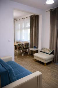 a living room with a blue couch and a table at Casa Centrale with Free Parking in Plovdiv