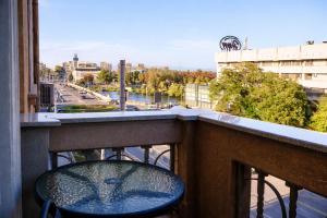 a chair on a balcony with a view of a city at Casa Centrale with Free Parking in Plovdiv